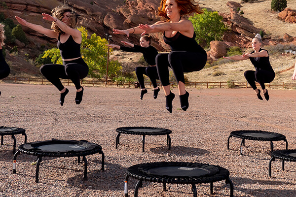 women bouncing on a trampoline